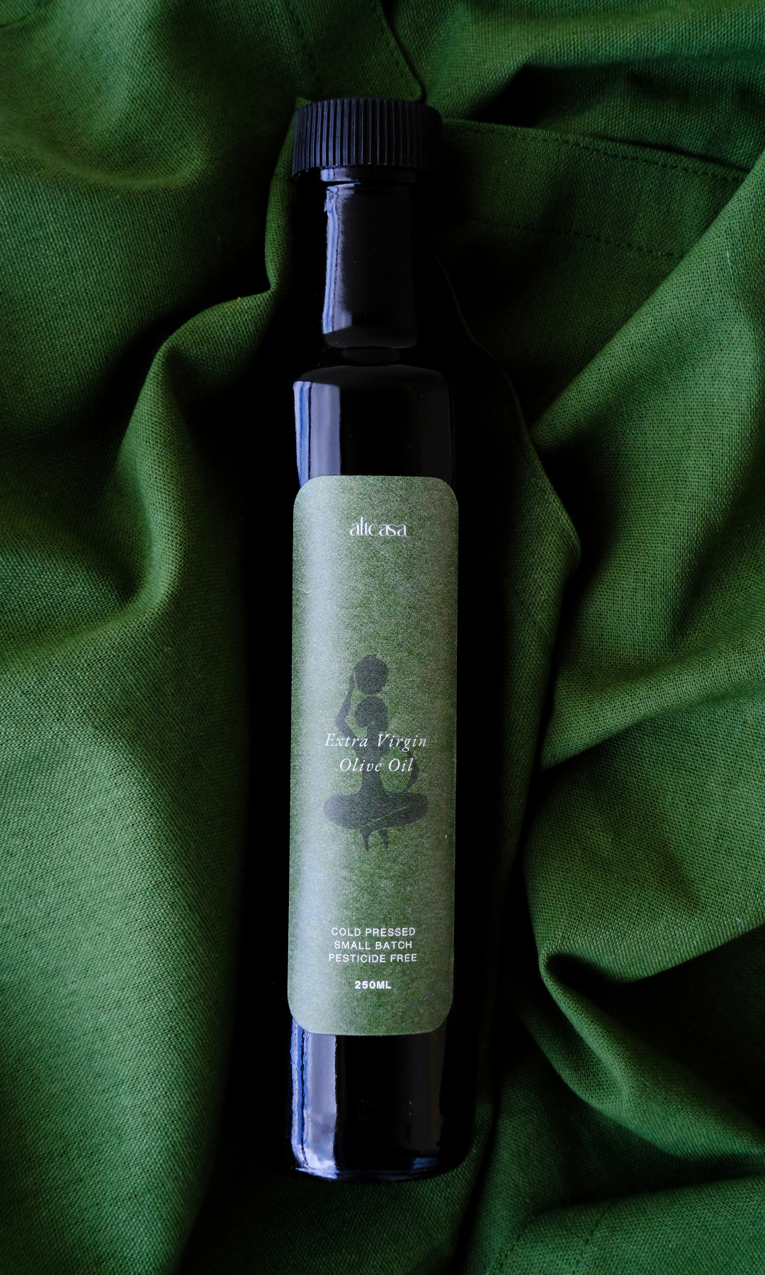 cold-pressed olive oil on green linen cloth cape town
